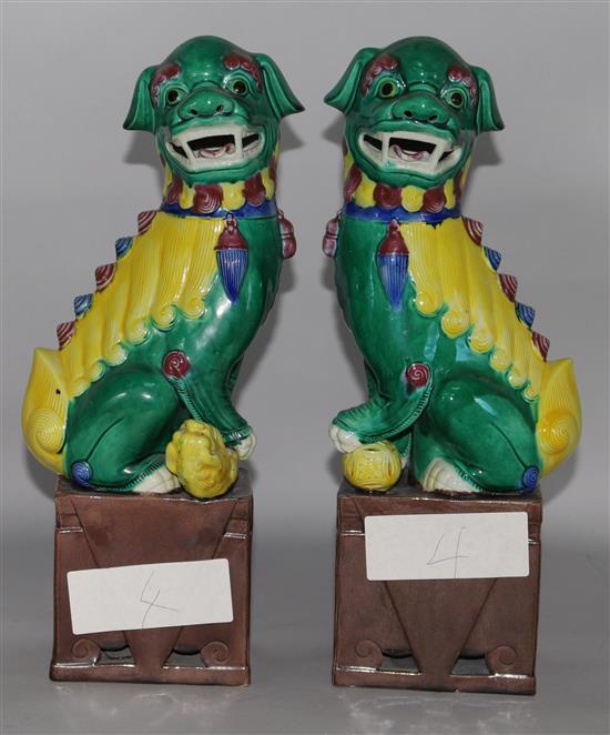 A pair of Chinese green and yellow glazed dogs of fo